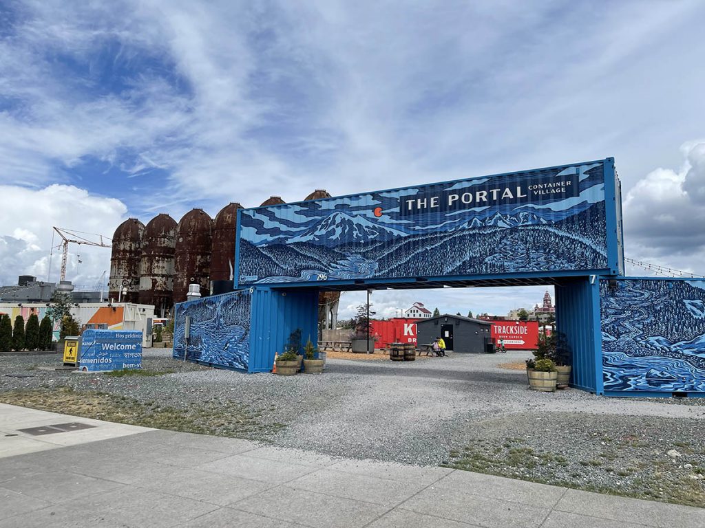 main entrance to the portal container village with places to eat or rent a bicycle.